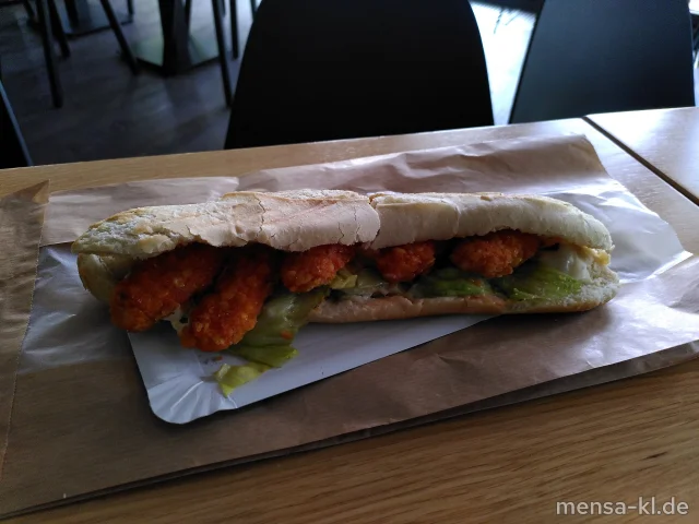 Paniertes Hähnchenfilet im Brötchen belegt mit Remoulade, Sweet-Chili-Soße, Zwiebeln und Salat (1,9,Gl,Ei,La,Sl,Sf,G)