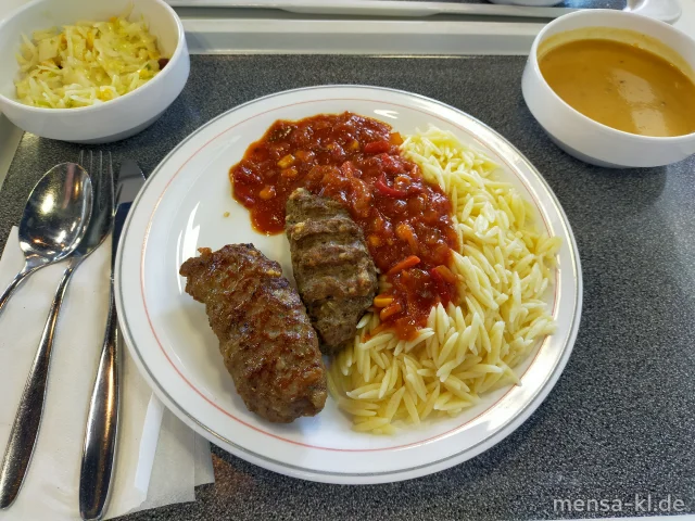 Bifteki (Rinderhack-Medaillons mit Hirtenkäse gefüllt) (Gl,Ei,La,Sl,Sf,R) mit Pusztasoße (9,Sl), Nudel-Reis (Gl,Ei) und Krautsalat (1,5,Sw)