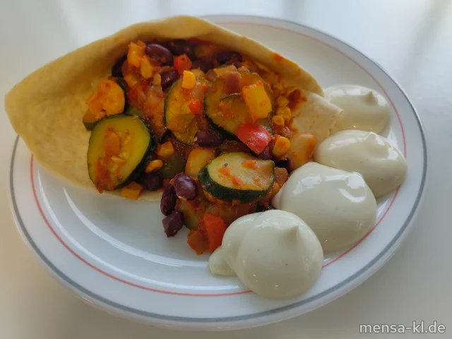 "Fajita Pueblo" mit Kidneybohnen, weiße Bohnen, Paprika, Zucchini und Zwiebeln in mexikanischer Soße (Gl), dazu veganer Sour Cream-Dip (Gl,Nu,Sf), Tortillas (Gl) und Salat